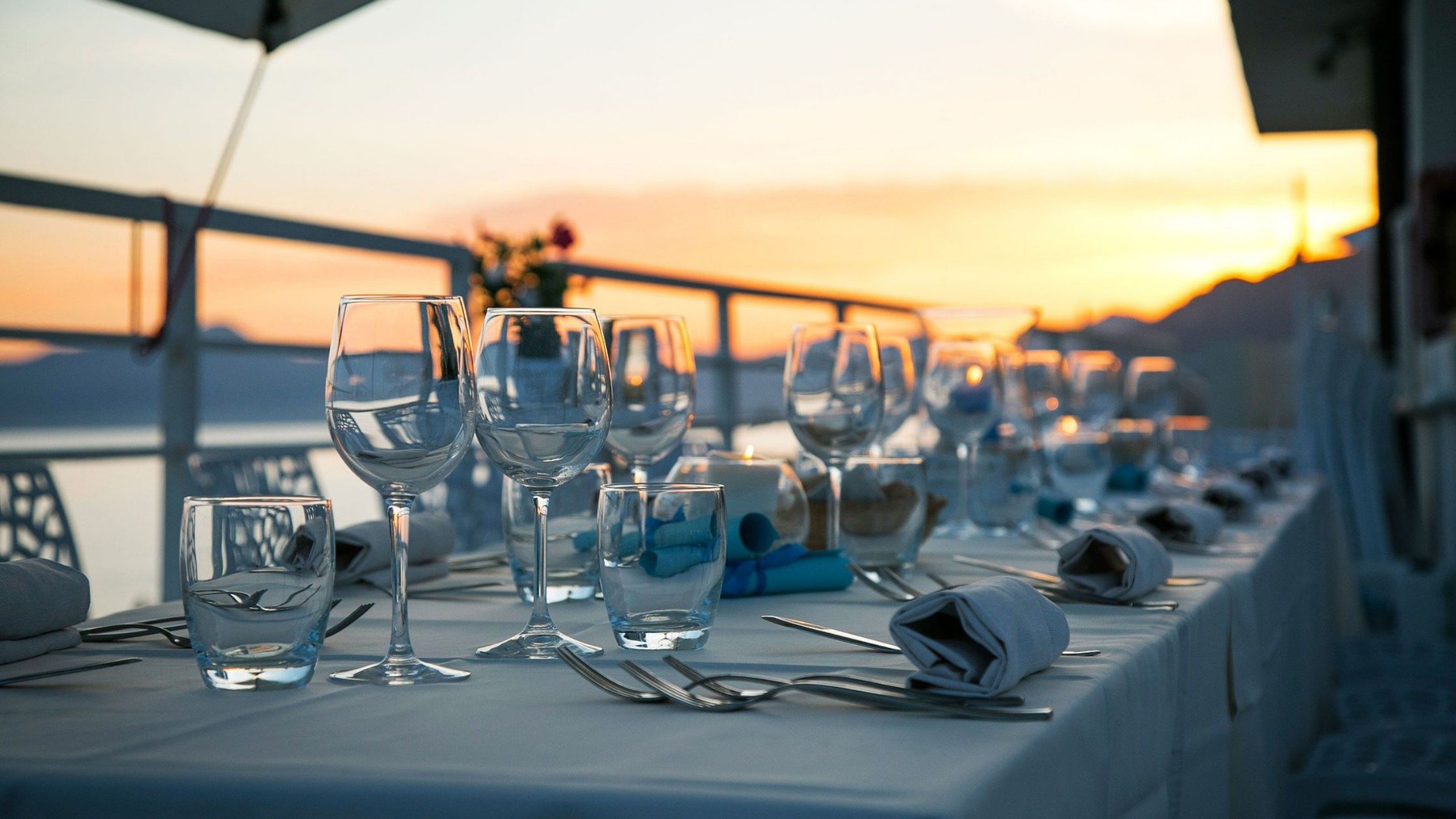 Restaurant glassware with sunset background.
