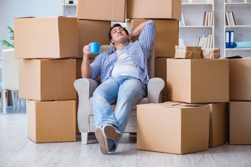 Man taking a break after packing boxes.